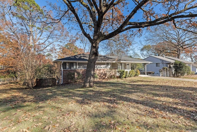 ranch-style house with a front lawn