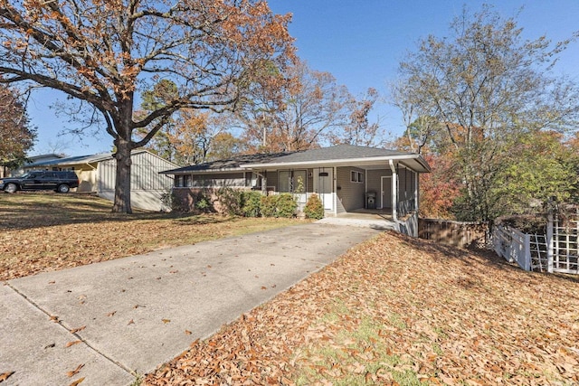 ranch-style home with a front yard and a carport