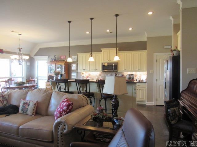 living room with a chandelier and ornamental molding