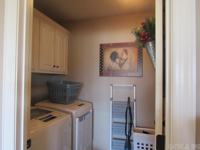 laundry area featuring washer and dryer and cabinets