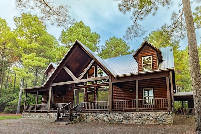 log-style house featuring a porch