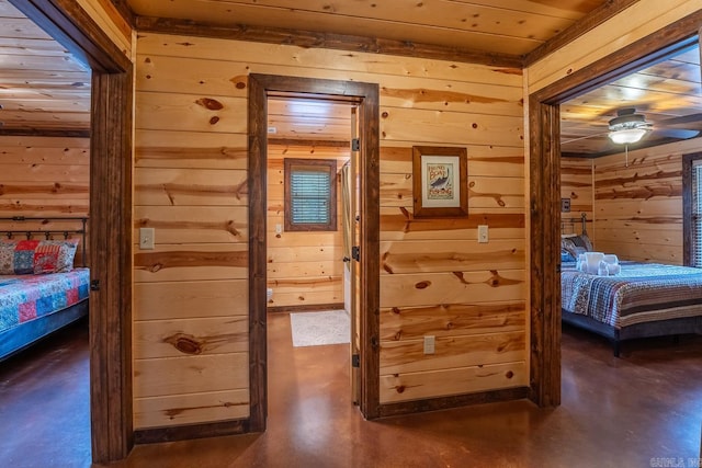 unfurnished bedroom featuring wooden ceiling and wooden walls