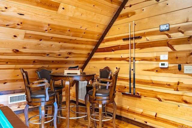 bar featuring hardwood / wood-style floors, wood walls, lofted ceiling, and wooden ceiling