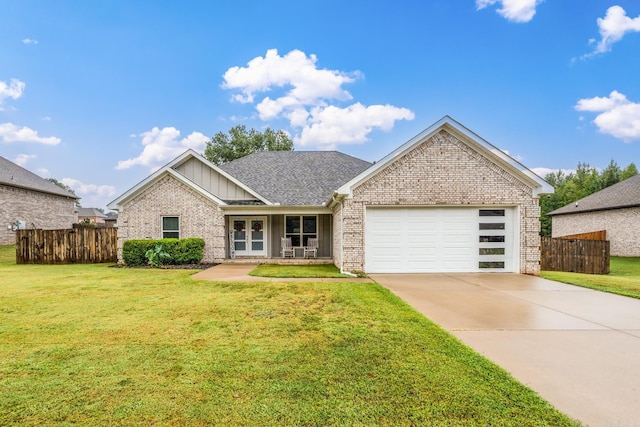 view of front of home with a front yard and a garage