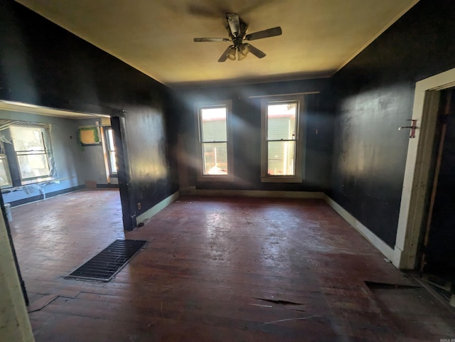 empty room with ceiling fan and dark hardwood / wood-style floors