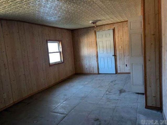 empty room featuring wooden walls