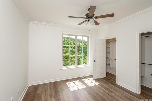 unfurnished bedroom with hardwood / wood-style floors, ceiling fan, and crown molding