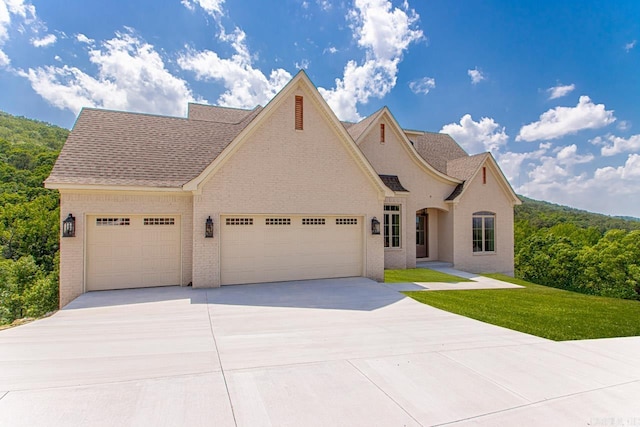 view of front of property with a garage and a front lawn