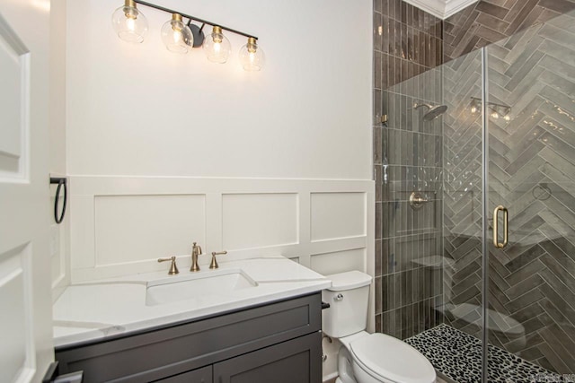 bathroom with vanity, an enclosed shower, and toilet