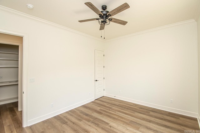 unfurnished room featuring hardwood / wood-style floors, ceiling fan, and ornamental molding