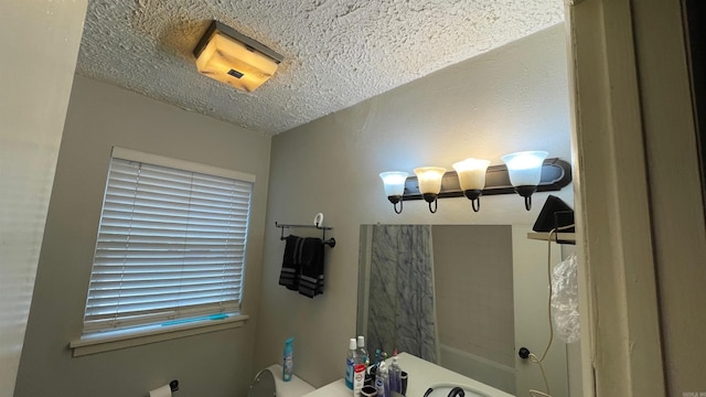 bathroom with shower / bathtub combination and a textured ceiling