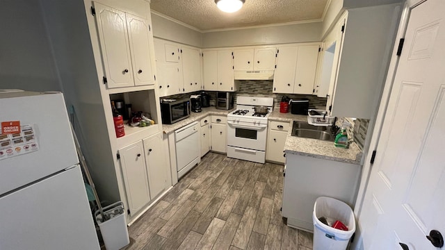 kitchen with white appliances, sink, a textured ceiling, dark hardwood / wood-style flooring, and white cabinetry