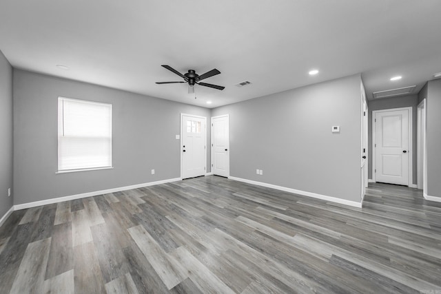 spare room with ceiling fan and wood-type flooring