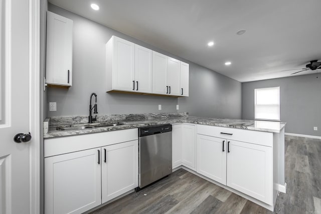 kitchen featuring dishwasher, sink, kitchen peninsula, wood-type flooring, and white cabinets