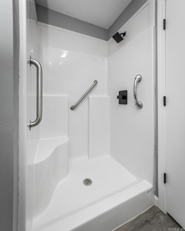 bathroom with hardwood / wood-style floors and walk in shower