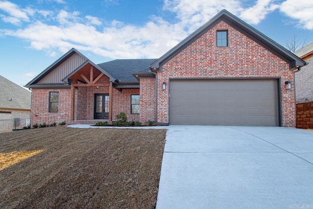 view of front facade with a front yard, french doors, and a garage