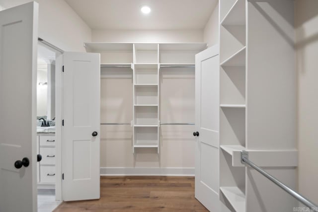 walk in closet featuring hardwood / wood-style flooring