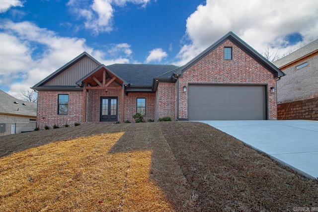 view of front of home with a garage, a front yard, and french doors