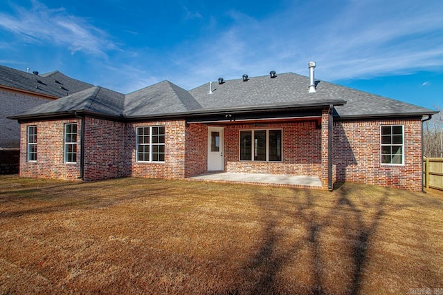 rear view of property featuring a patio area and a yard