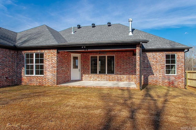 rear view of property featuring a yard and a patio