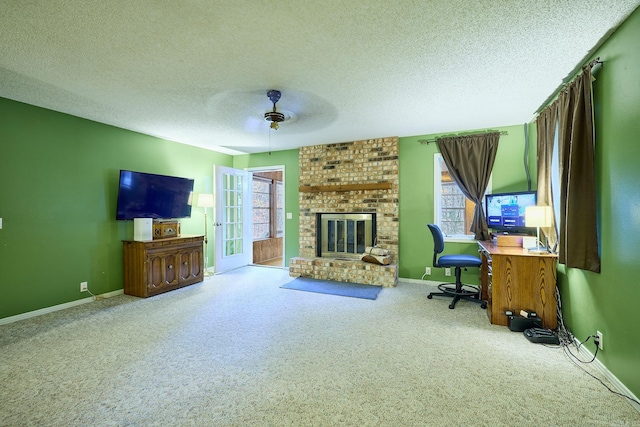 living room with carpet flooring, ceiling fan, a healthy amount of sunlight, and a brick fireplace