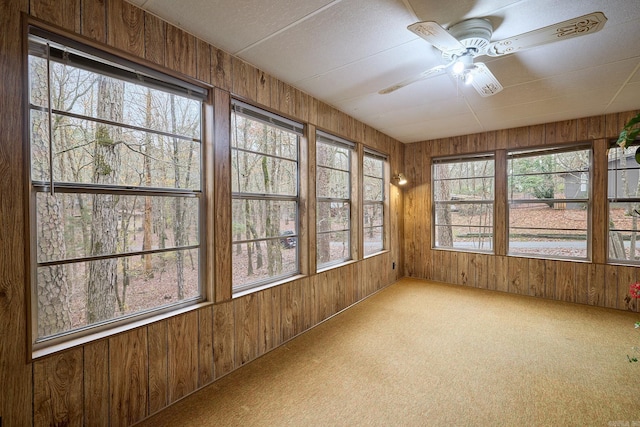 unfurnished sunroom featuring a wealth of natural light and ceiling fan