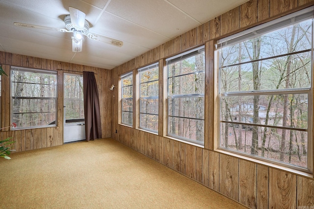 unfurnished sunroom featuring ceiling fan