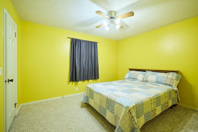 bedroom with light carpet, ceiling fan, and a textured ceiling