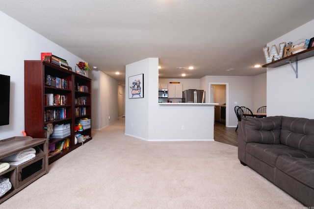 carpeted living room featuring a textured ceiling