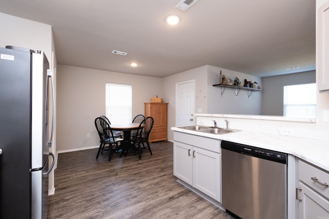 kitchen with white cabinetry, dark hardwood / wood-style flooring, stainless steel appliances, and sink