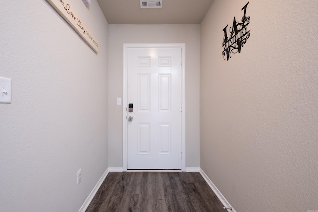 doorway with dark wood-type flooring