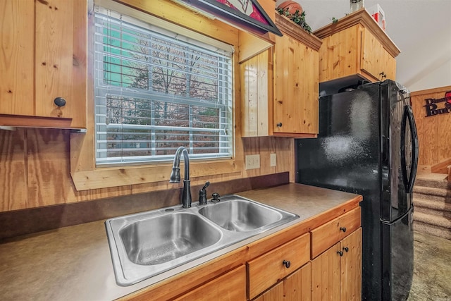 kitchen with black refrigerator and sink