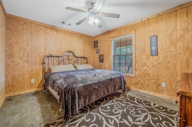 bedroom with dark carpet, ceiling fan, and wood walls