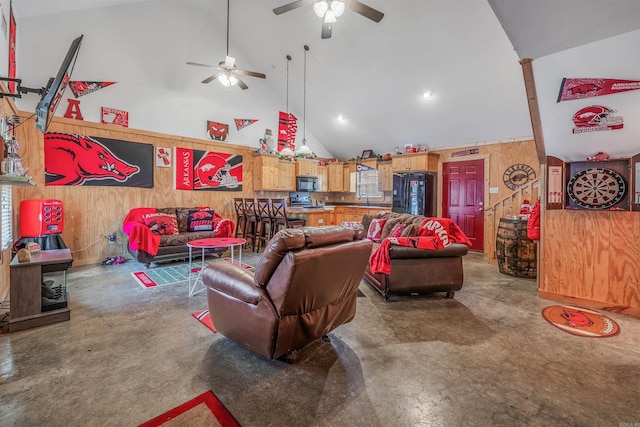 living room featuring wood walls, sink, high vaulted ceiling, and concrete flooring