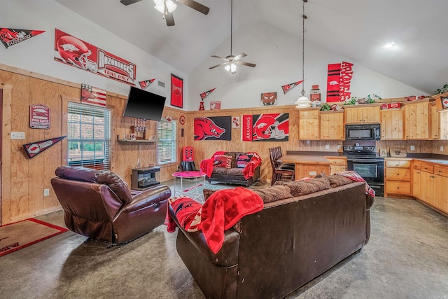 living room featuring ceiling fan, wood walls, light carpet, and high vaulted ceiling