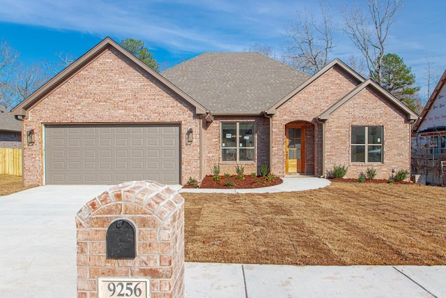 view of front of home with a front lawn and a garage