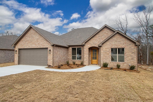 view of front of home with a garage and a front yard