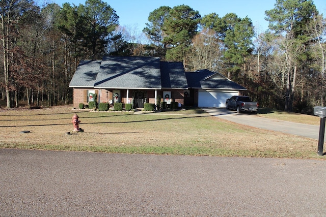 single story home featuring a front yard and a garage