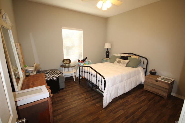 bedroom with ceiling fan and dark wood-type flooring