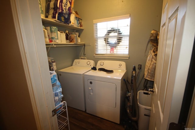 clothes washing area with dark hardwood / wood-style flooring and washer and dryer