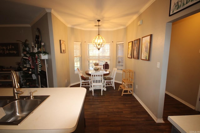 dining space featuring a chandelier, dark hardwood / wood-style flooring, ornamental molding, and sink