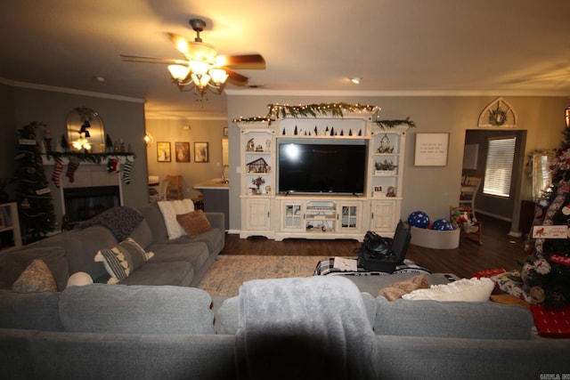 living room featuring hardwood / wood-style flooring, ceiling fan, and ornamental molding