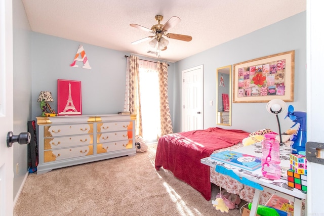 bedroom with carpet flooring, ceiling fan, and a textured ceiling