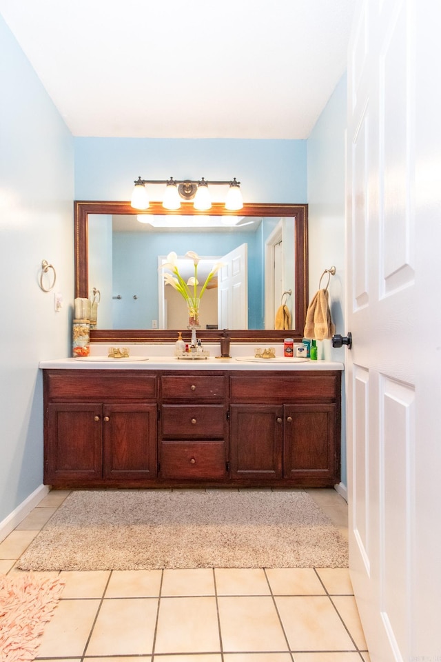 bathroom featuring tile patterned flooring and vanity