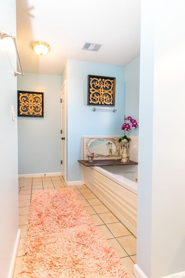 hallway featuring tile patterned flooring and a textured ceiling