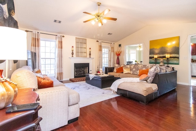 living room with dark hardwood / wood-style flooring, plenty of natural light, and lofted ceiling