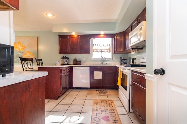 kitchen featuring kitchen peninsula, sink, light tile patterned flooring, and white appliances