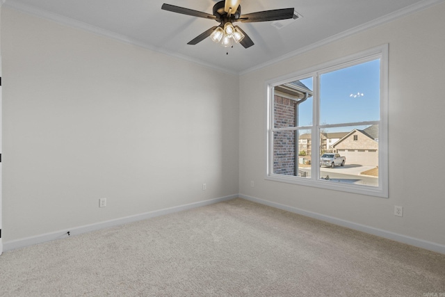 carpeted spare room with ceiling fan and crown molding