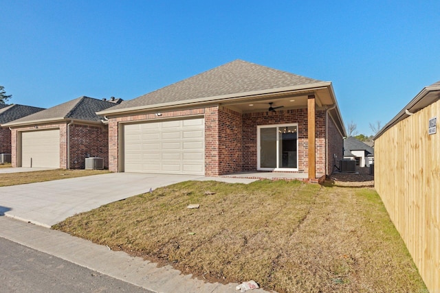 view of front of property featuring central AC, ceiling fan, a front yard, and a garage