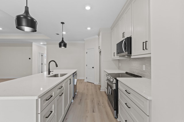 kitchen with white cabinetry, sink, pendant lighting, and appliances with stainless steel finishes